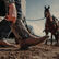  Man pulling on Durango Shyloh western boots on horse trailer