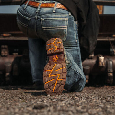 Man working on machine wearing Workin' Rebel™ Durango work boots 